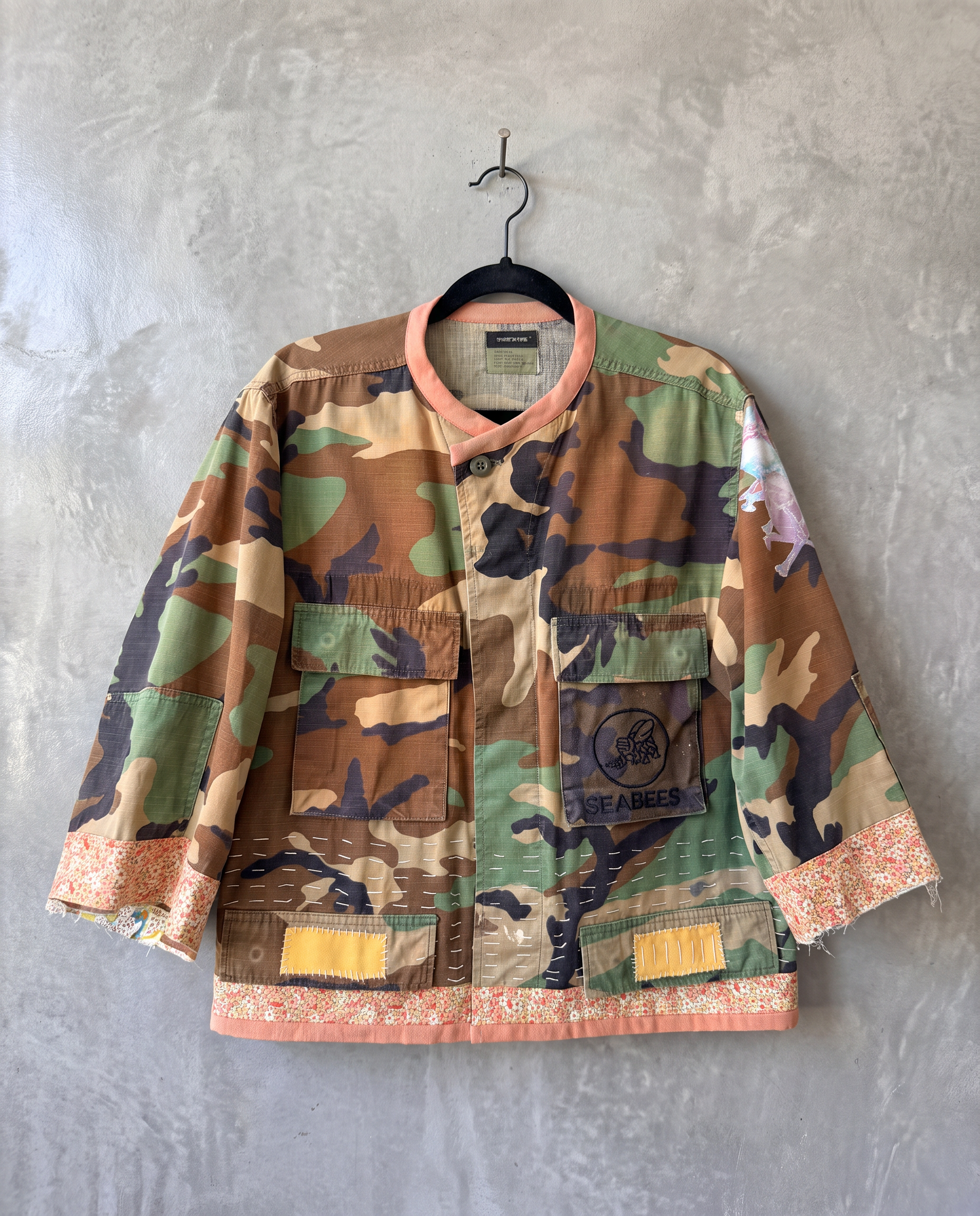 Music Head jacket, front view, laid flat, showing peach collar and hem detail.
